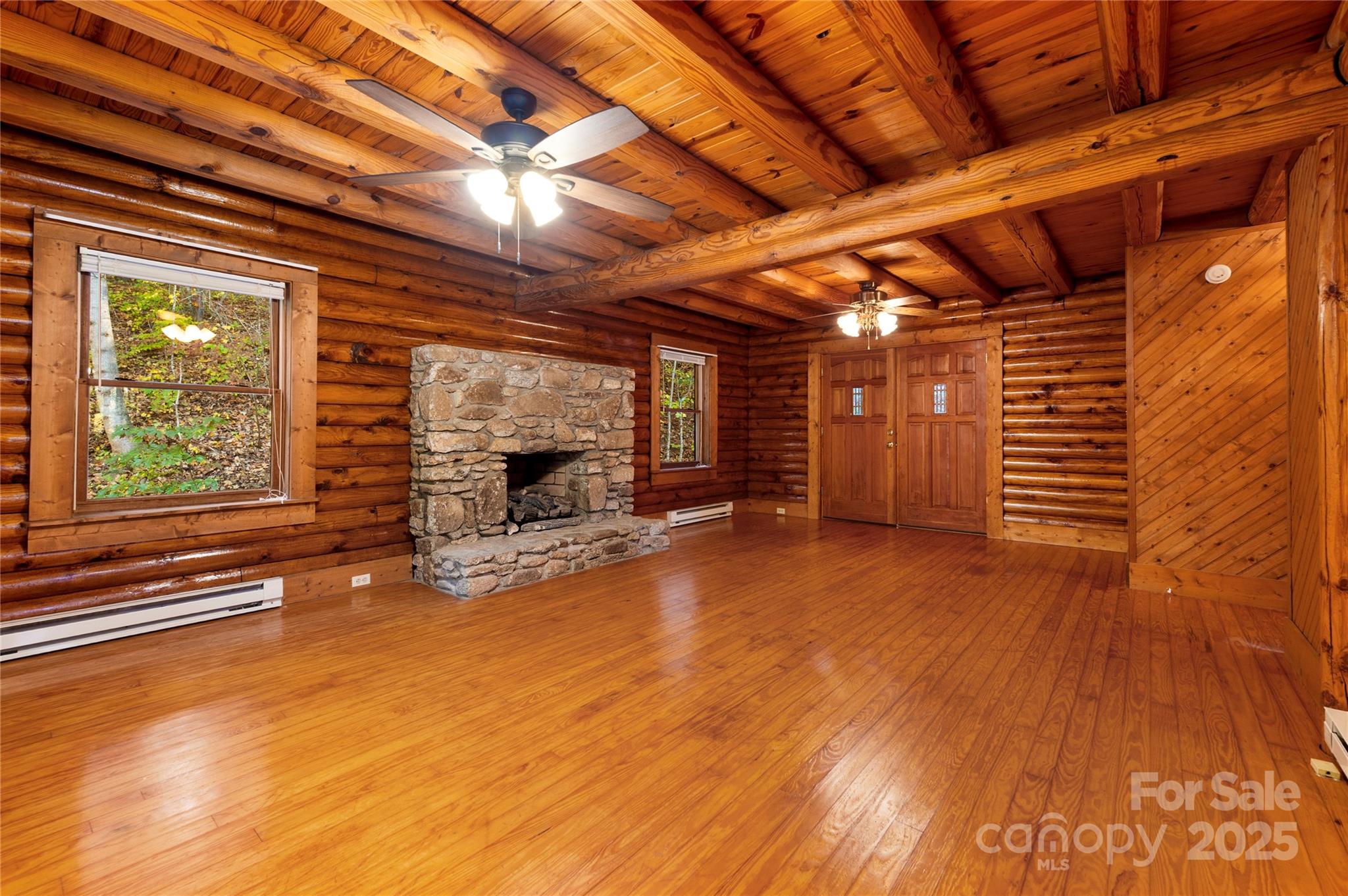 5 Rustic Rdg Drive Candler, NC 28715 - Photo 5 of 17 a view of an empty room with wooden floor and a window