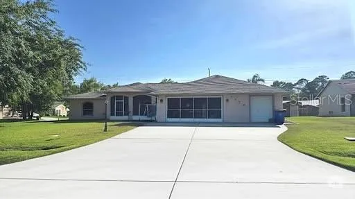 a front view of house with yard and green space
