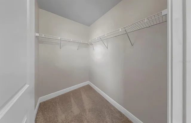 an aerial view of a house with a yard and outdoor seating