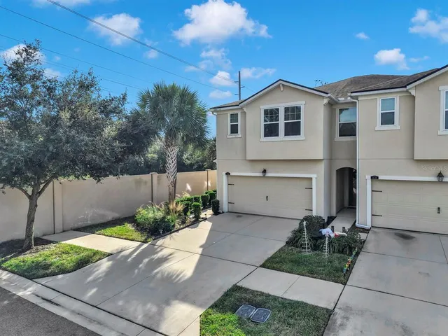 a large kitchen with stainless steel appliances kitchen island granite countertop a large counter top and wooden floors