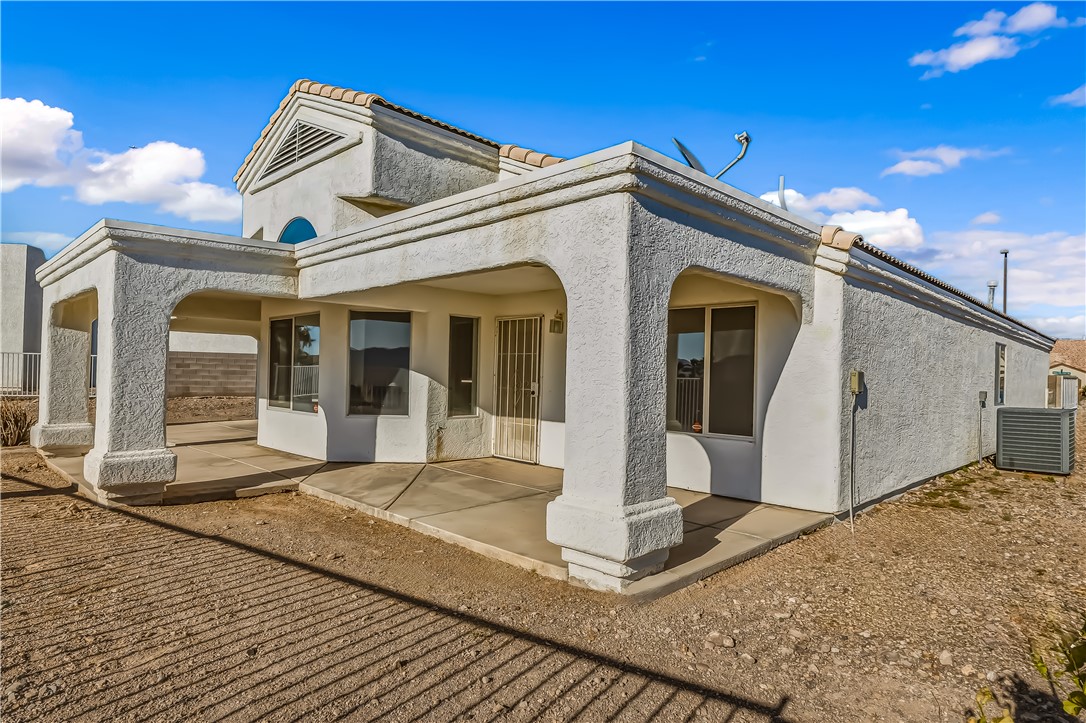 2853 Winchester Road Bullhead City, AZ 86442 - Photo 33 of 40 Stucco exterior with a tiled roofline and arched entryway