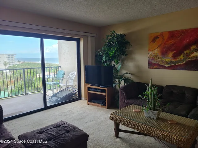 a view of a dining room with furniture and window