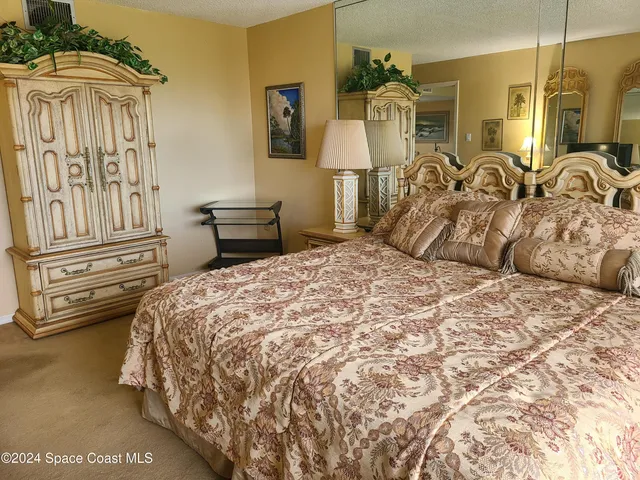 a bedroom with a bed and a television in it