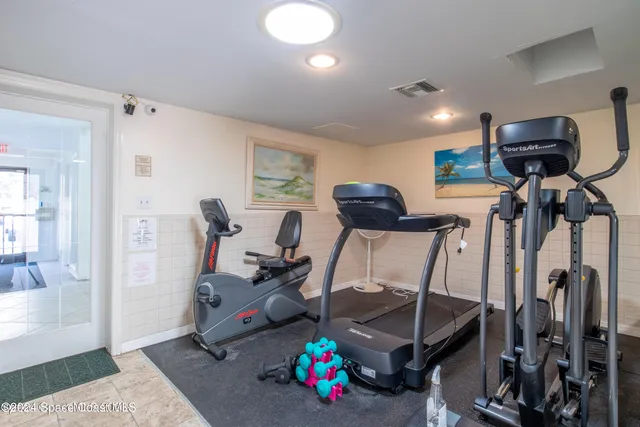 a view of a house with a yard and basketball court