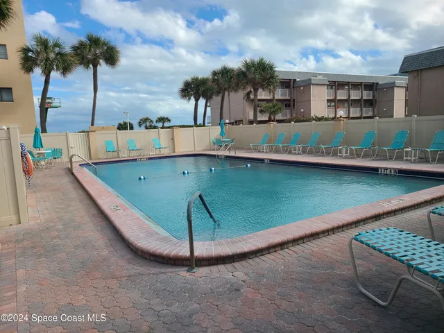 a view of a lake with two chairs