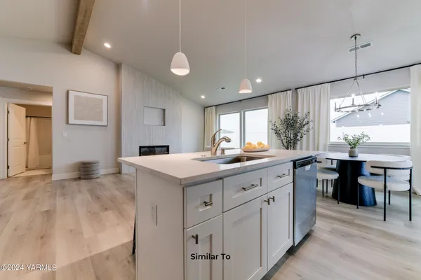 a kitchen with cabinets and window
