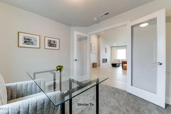 a view of a livingroom with furniture and a table