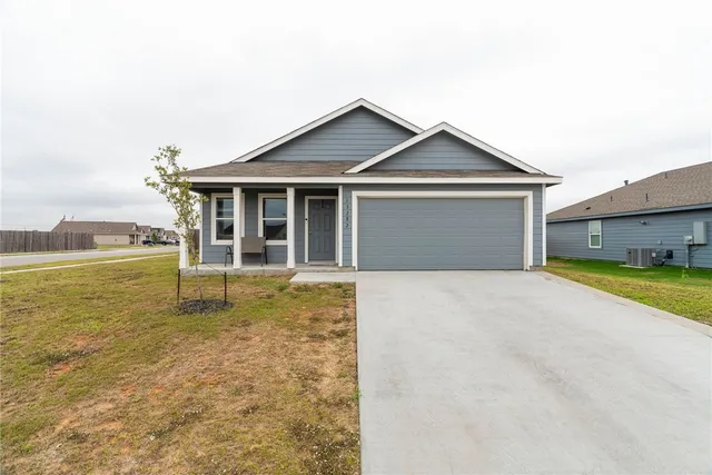 a view of house with pool and yard