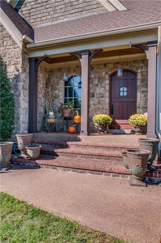 4219 Two Rivers Lane Franklin, TN 37069 - Photo 2 of 20 a front view of a house with outdoor seating