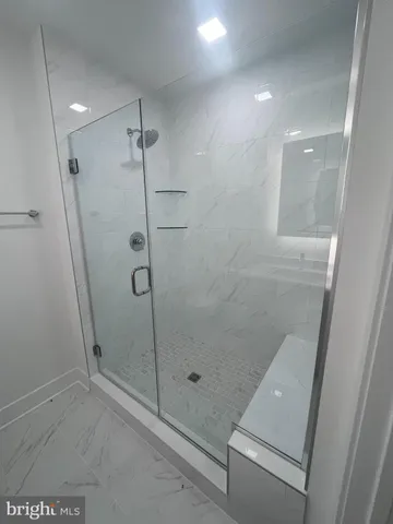 a bathroom with a granite countertop sink toilet and mirror