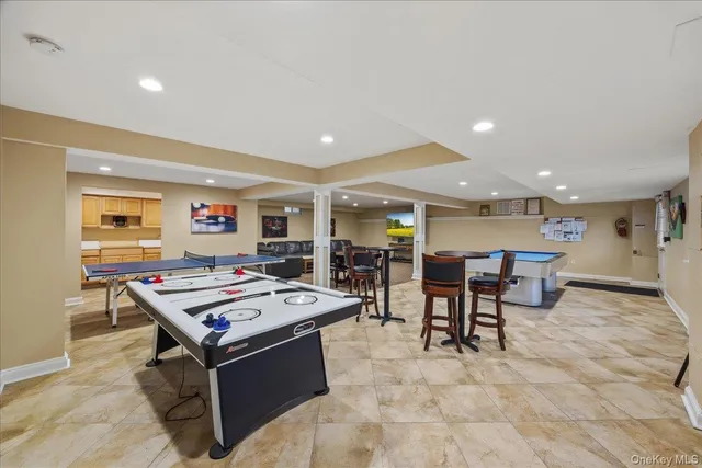 a living room with stainless steel appliances lots of furniture and rug