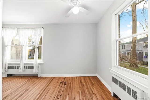 a view of wooden floor and a chandelier in a room