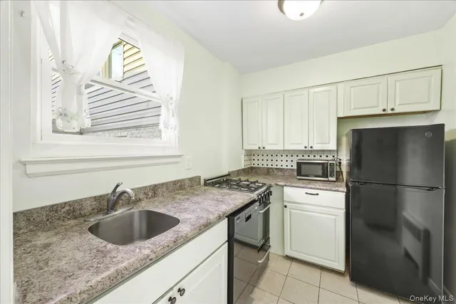 a kitchen with a sink stove and refrigerator