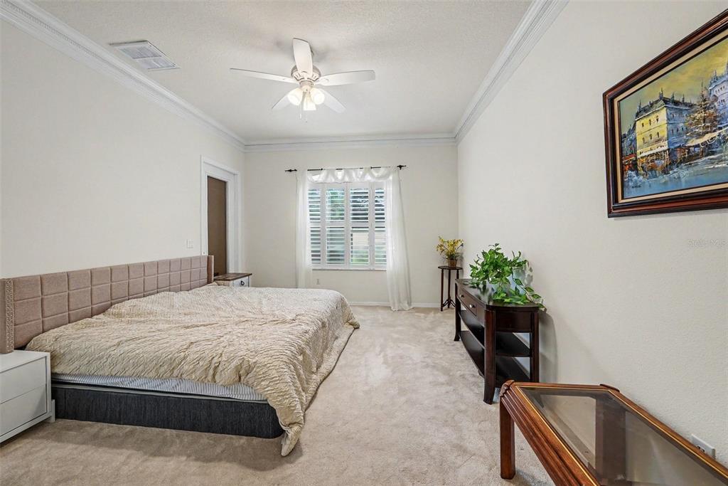 7411 Wimpole Drive New Port Richey, FL 34655 - Photo 11 of 21 a bedroom with a bed and a chandelier