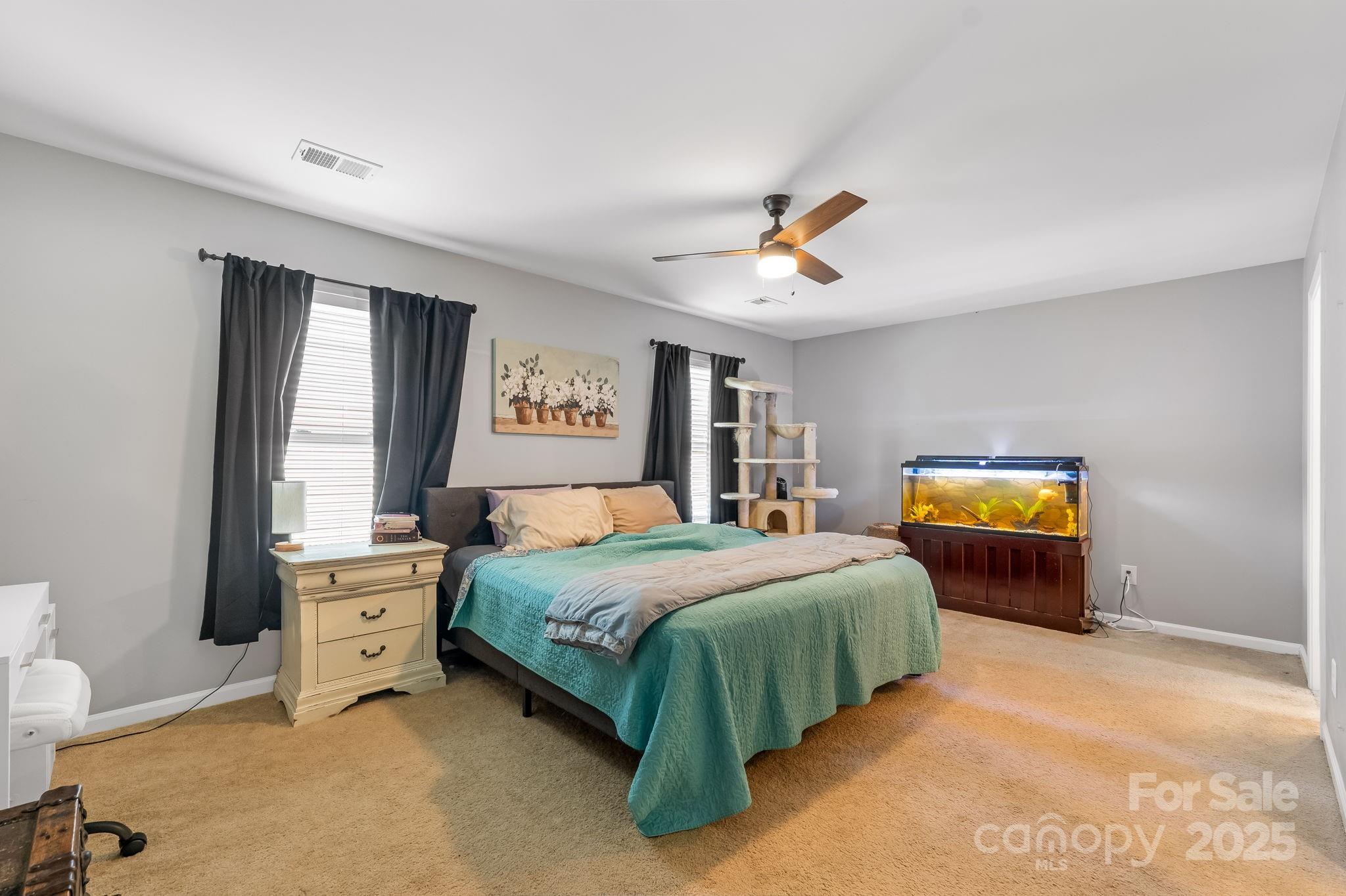 4246 Lotts Place Rock Hill, SC 29732 - Photo 11 of 24 a bedroom with a bed and a chandelier