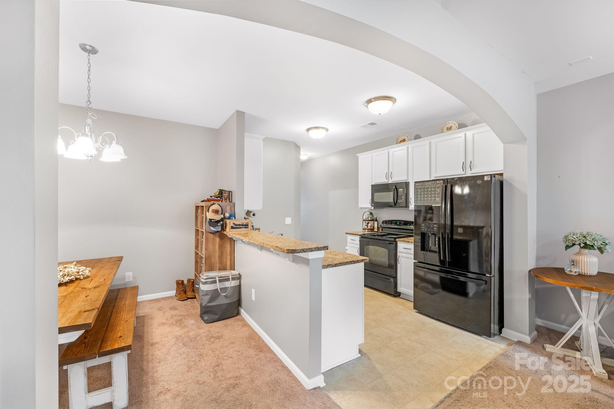 4246 Lotts Place Rock Hill, SC 29732 - Photo 8 of 24 a kitchen with stainless steel appliances kitchen island granite countertop a refrigerator and a stove top oven