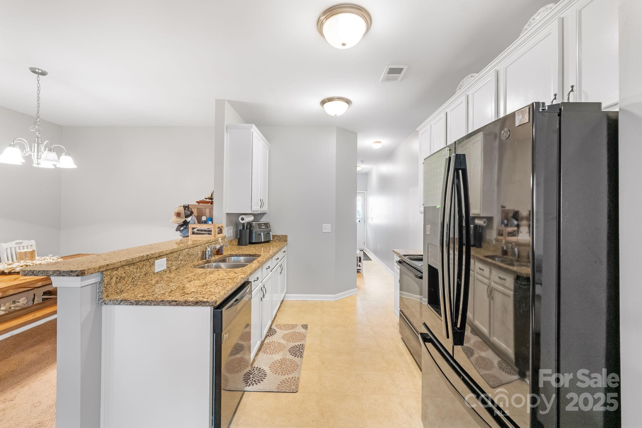 4246 Lotts Place Rock Hill, SC 29732 - Photo 9 of 24 a kitchen with granite countertop a refrigerator and a sink
