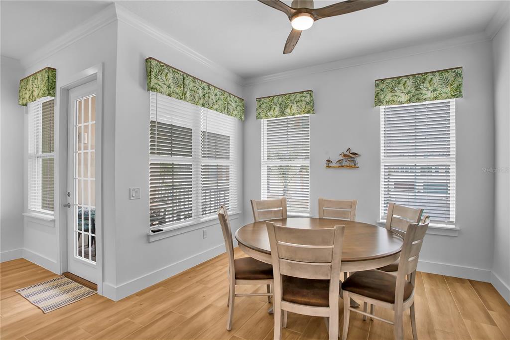 19915 Gulf Boulevard, Unit 204 Indian Rocks Beach, FL 33785 - Photo 16 of 47 a view of a dining room with furniture and wooden floor