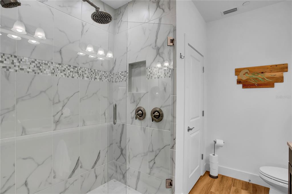 19915 Gulf Boulevard, Unit 204 Indian Rocks Beach, FL 33785 - Photo 26 of 47 a bathroom with a shower a toilet and a shower