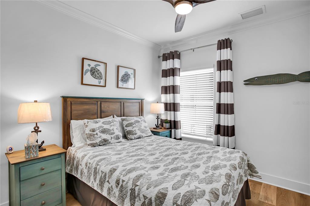 19915 Gulf Boulevard, Unit 204 Indian Rocks Beach, FL 33785 - Photo 29 of 47 a bedroom with a bed and a lamp