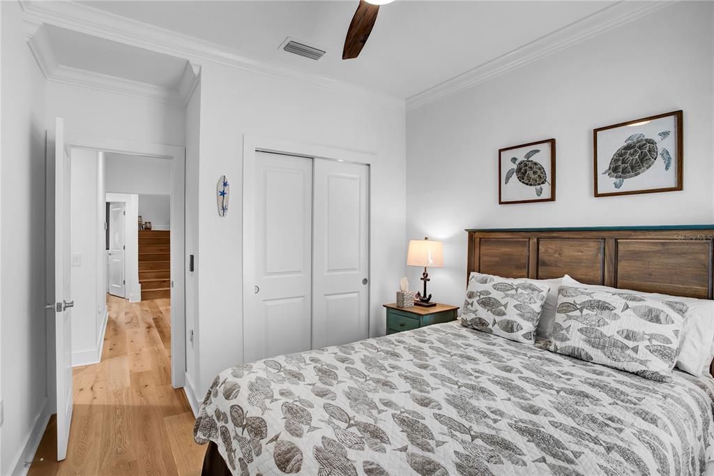 19915 Gulf Boulevard, Unit 204 Indian Rocks Beach, FL 33785 - Photo 30 of 47 a bedroom with a bed and painting on the wall