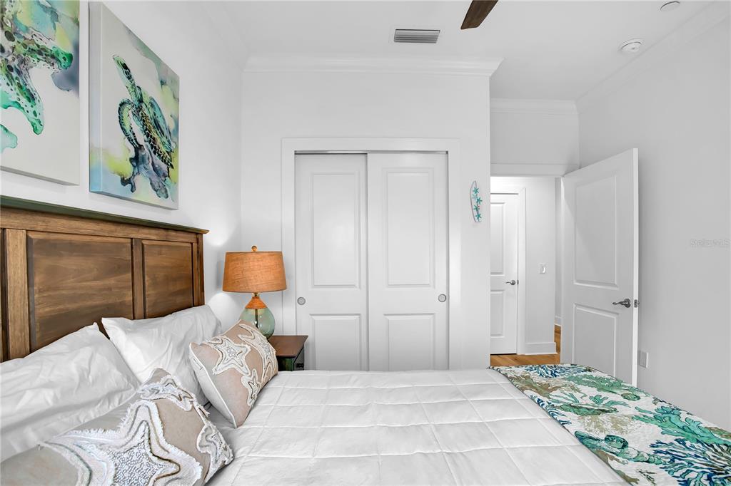 19915 Gulf Boulevard, Unit 204 Indian Rocks Beach, FL 33785 - Photo 35 of 47 a bedroom with a bed and a painting on the wall