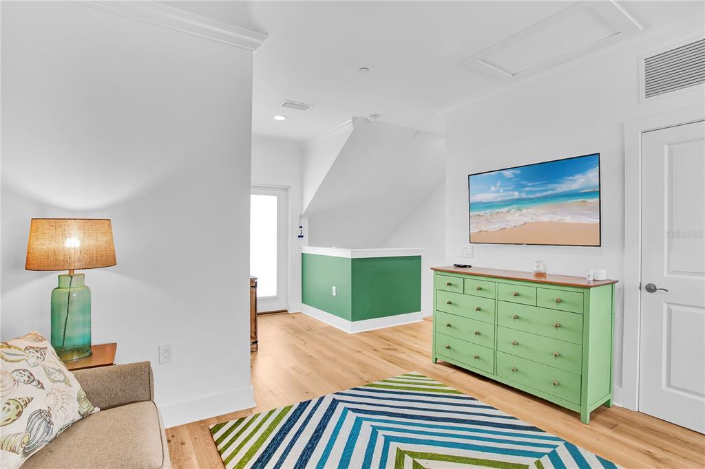 19915 Gulf Boulevard, Unit 204 Indian Rocks Beach, FL 33785 - Photo 37 of 47 a bedroom with a bed and a dresser in it