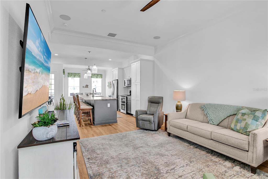 19915 Gulf Boulevard, Unit 204 Indian Rocks Beach, FL 33785 - Photo 8 of 47 a living room with furniture kitchen view and a potted plant