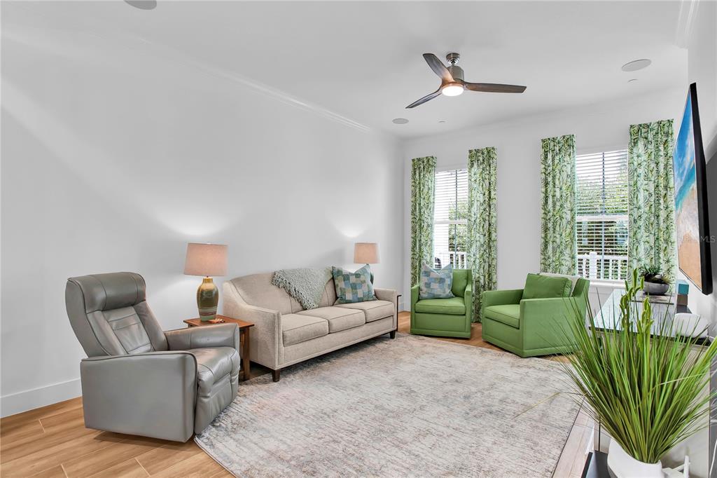 19915 Gulf Boulevard, Unit 204 Indian Rocks Beach, FL 33785 - Photo 9 of 47 a living room with furniture a large window and a chandelier