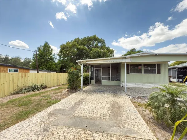 a view of a house with a backyard and a patio