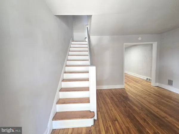 a view of an entryway with wooden floor
