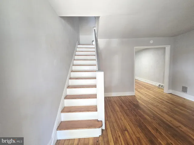 a view of an entryway with wooden floor