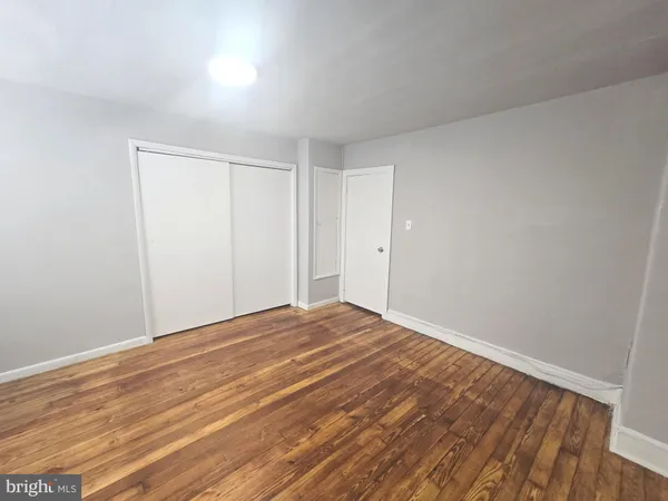 a view of an empty room and wooden floor