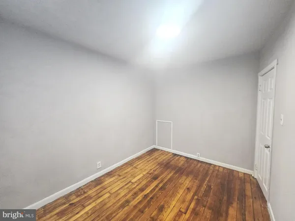 a view of a room with wooden floor