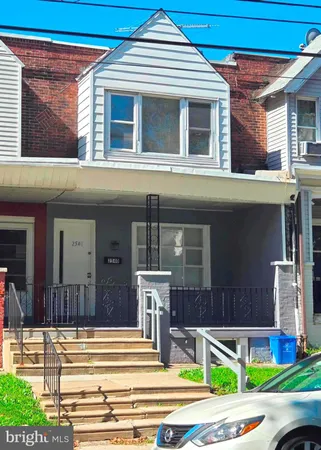 a view of a building with a yard and sitting area