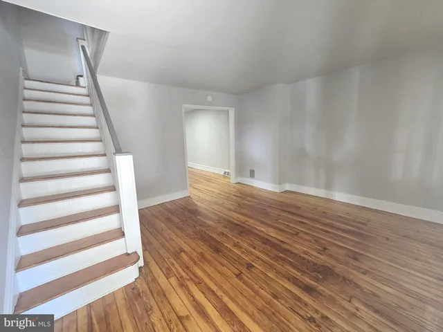 a view of wooden floor and windows in a room