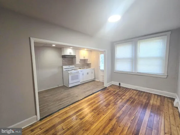 an empty room with windows and entrance