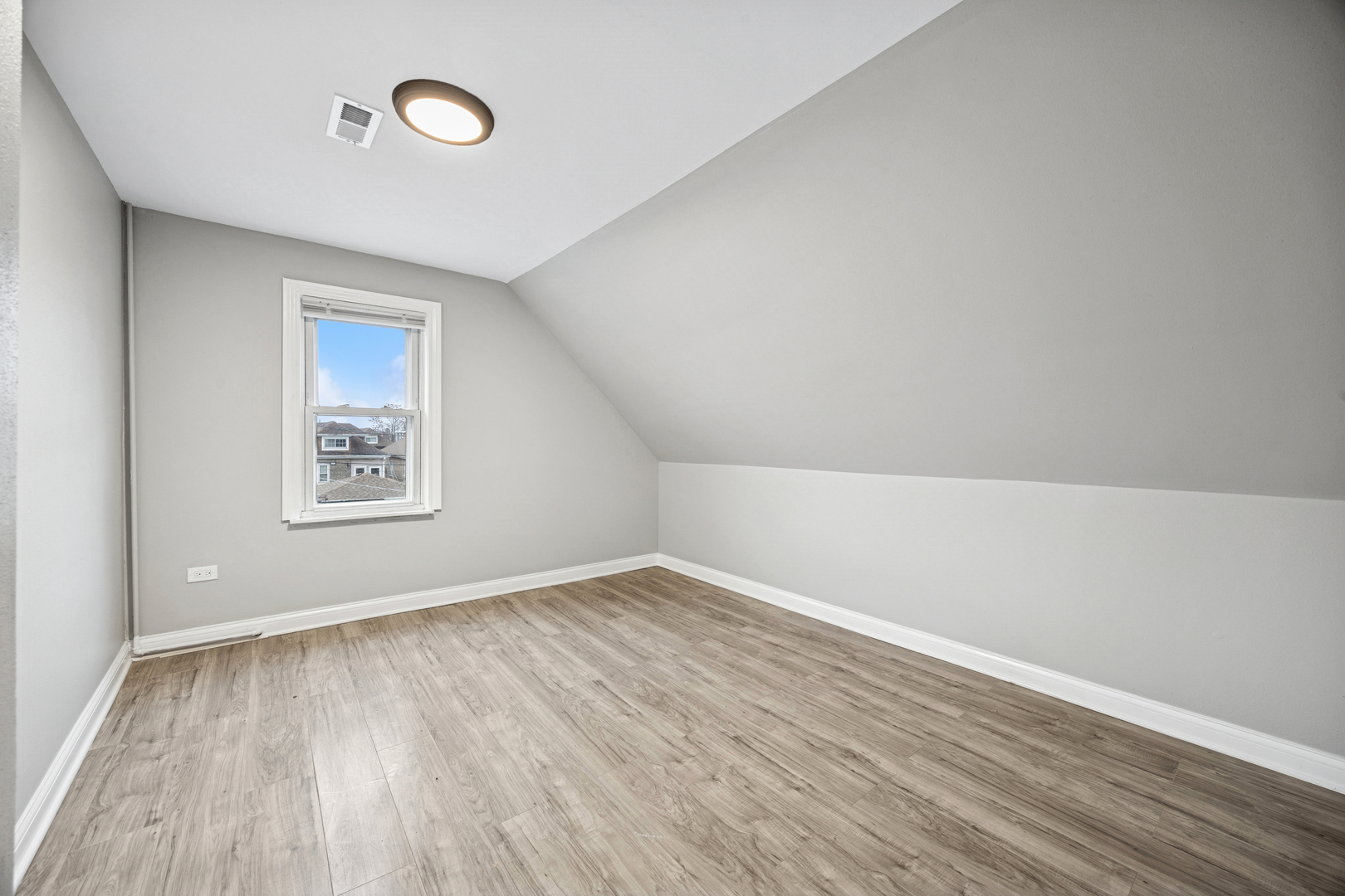5533 West 63rd Place Chicago, IL 60638 - Photo 11 of 20 an empty room with wooden floor and windows