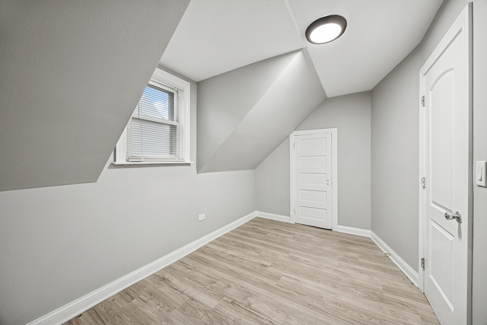 5533 West 63rd Place Chicago, IL 60638 - Photo 12 of 20 an empty room with wooden floor and windows