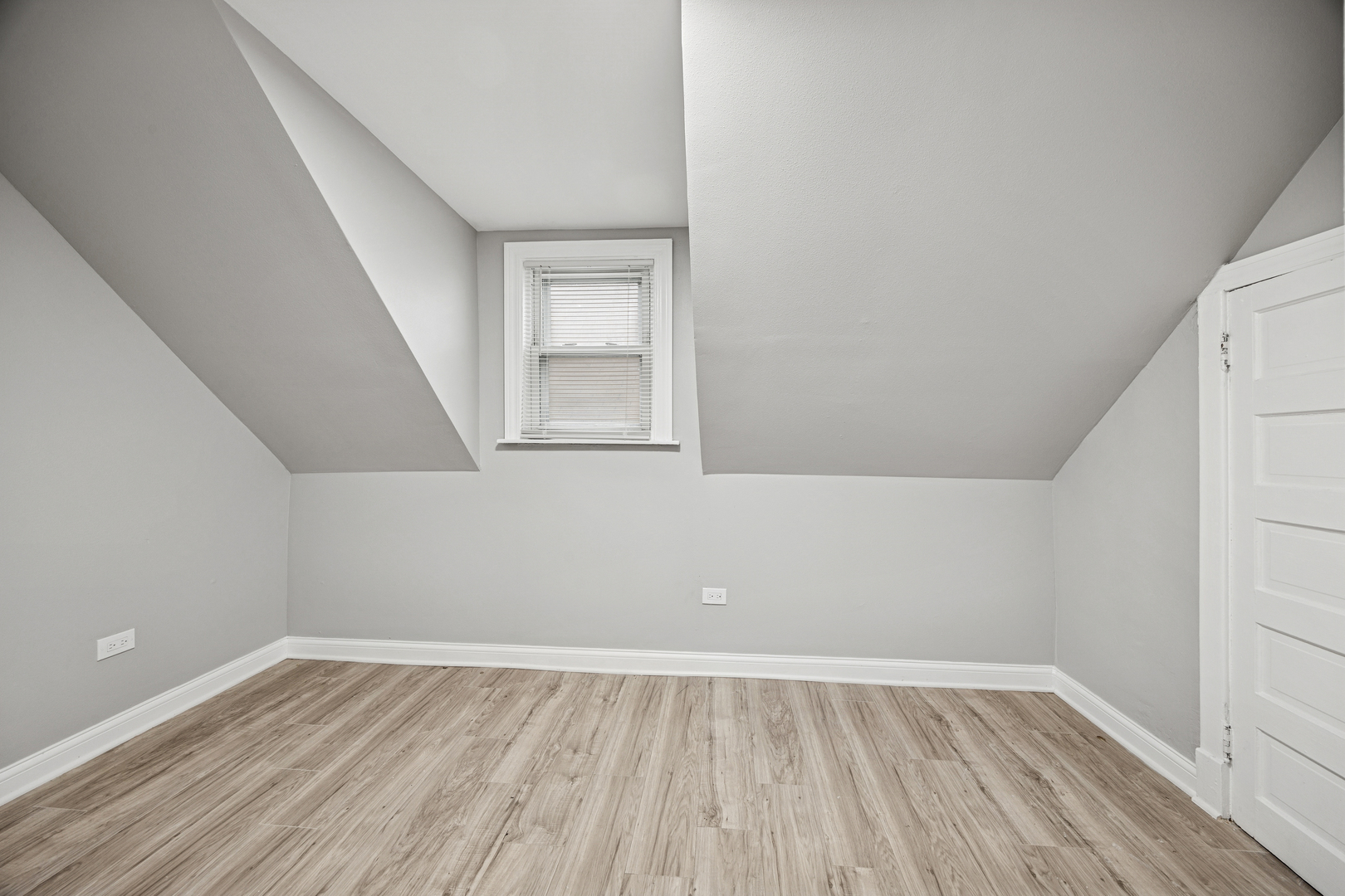 5533 West 63rd Place Chicago, IL 60638 - Photo 13 of 20 a view of an empty room with wooden floor and a window