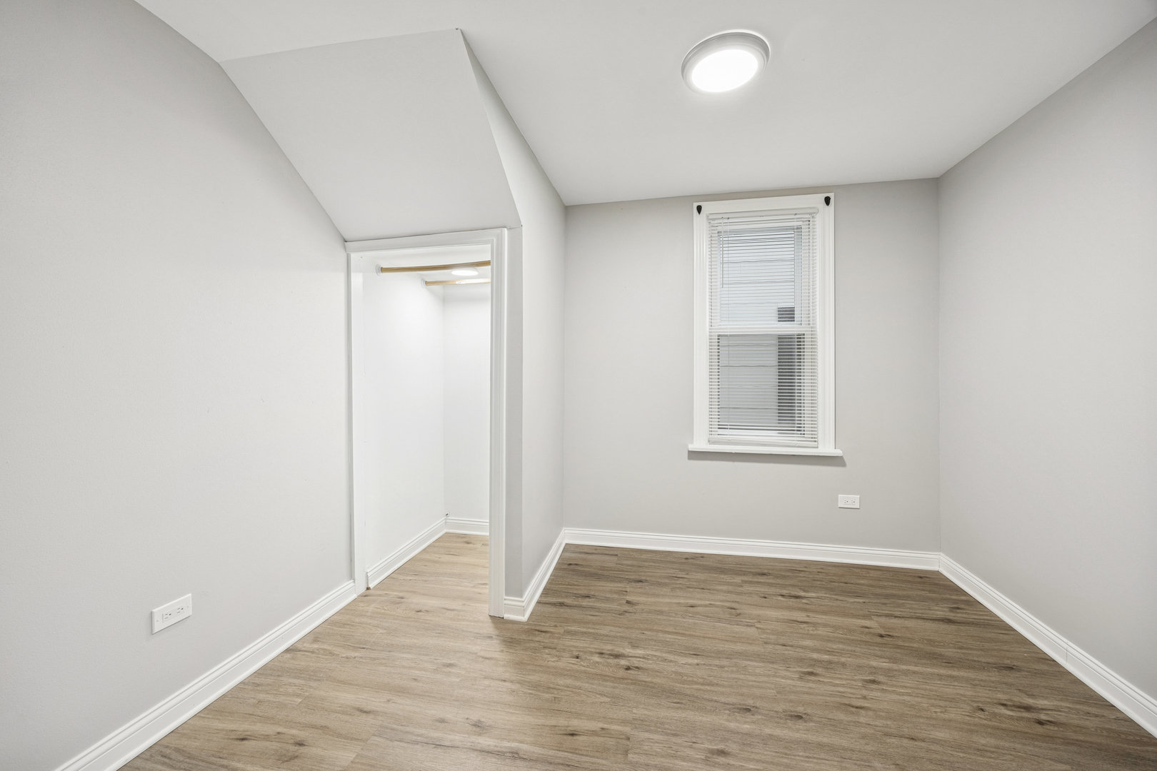 5533 West 63rd Place Chicago, IL 60638 - Photo 18 of 20 a view of an empty room with wooden floor and a window