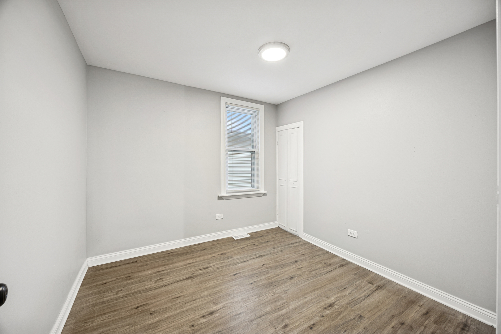 5533 West 63rd Place Chicago, IL 60638 - Photo 19 of 20 an empty room with wooden floor and windows