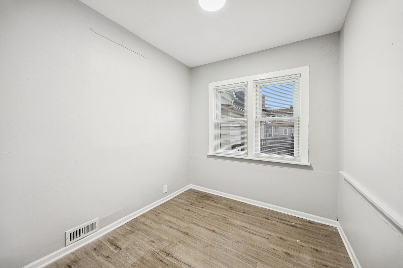 5533 West 63rd Place Chicago, IL 60638 - Photo 20 of 20 a view of empty room with wooden floor and fan