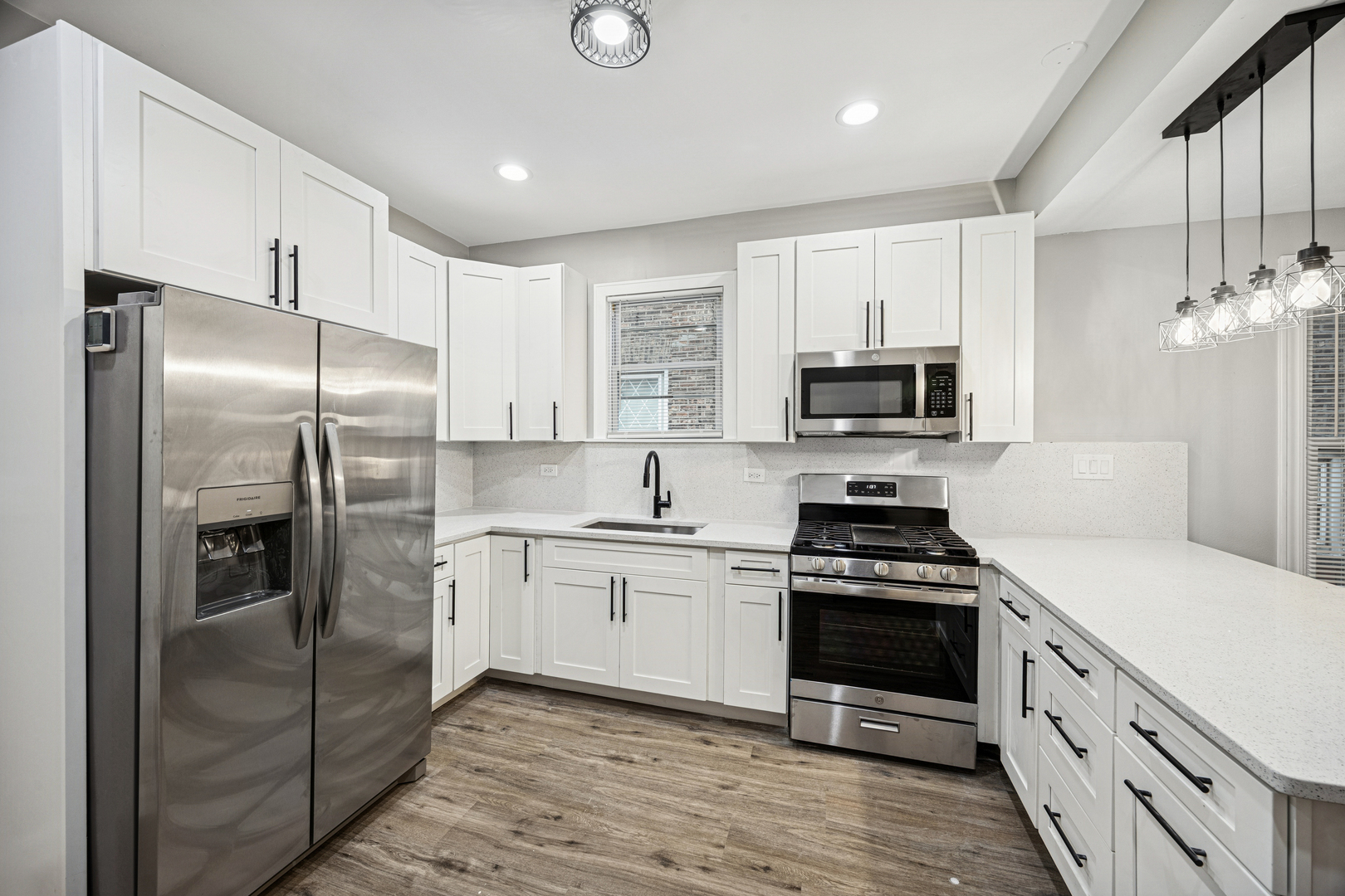 5533 West 63rd Place Chicago, IL 60638 - Photo 4 of 20 a kitchen with stainless steel appliances granite countertop a stove a refrigerator and a sink
