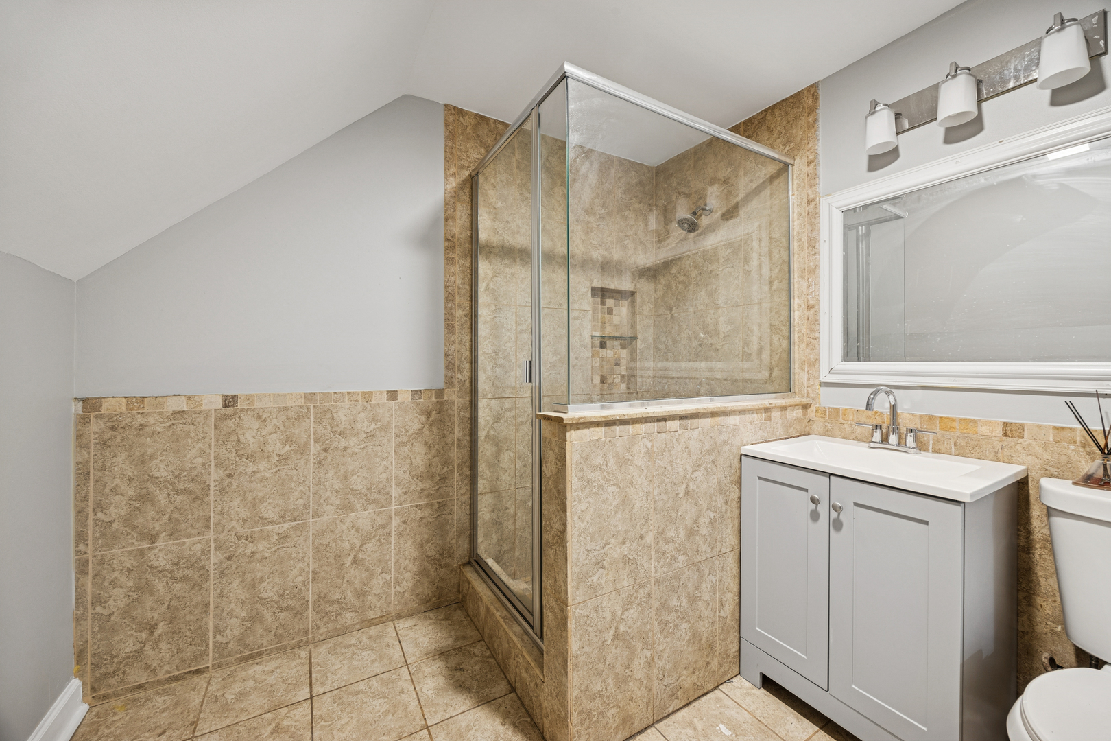 5533 West 63rd Place Chicago, IL 60638 - Photo 7 of 20 a bathroom with a shower sink and mirror