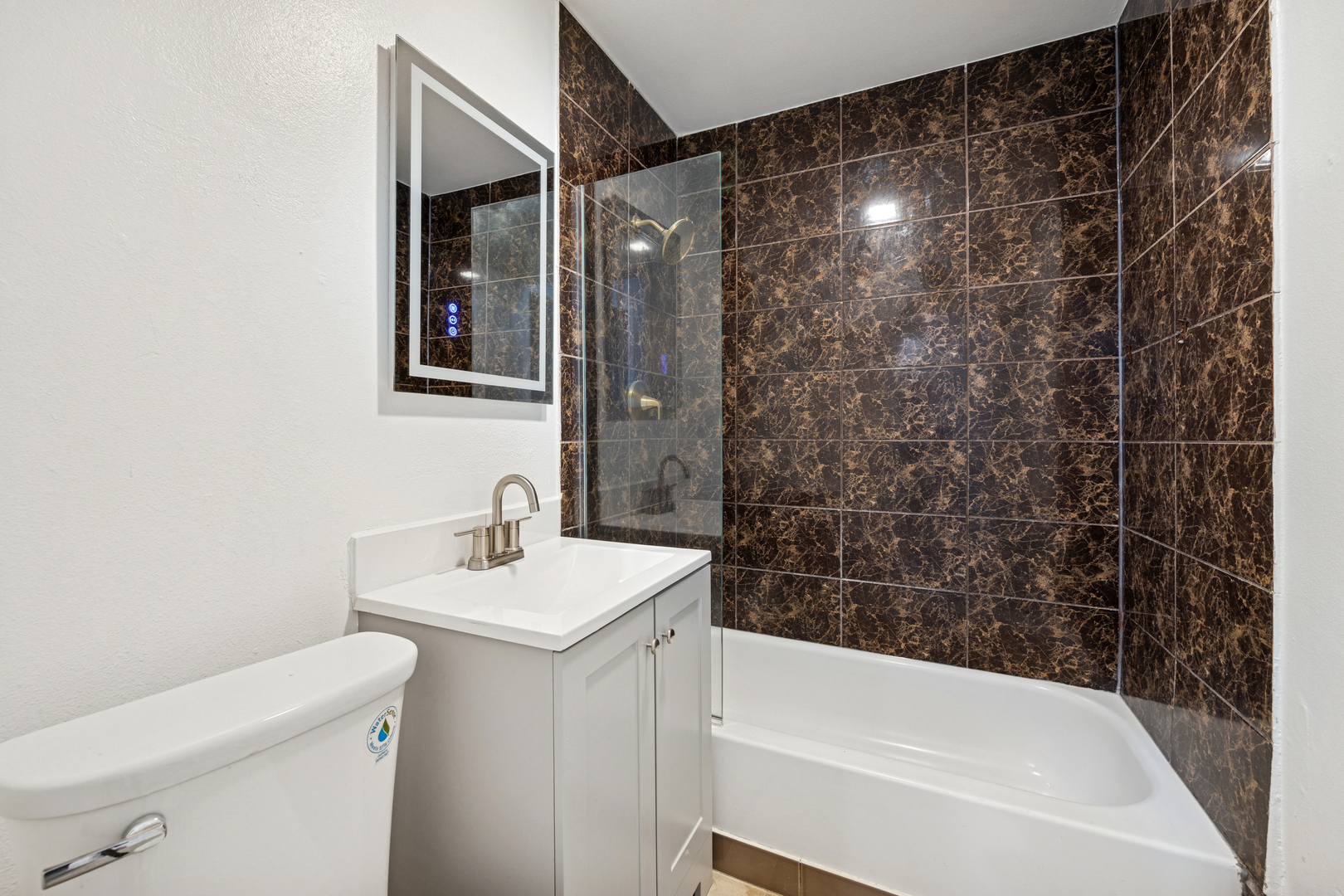 5533 West 63rd Place Chicago, IL 60638 - Photo 8 of 20 a bathroom with a sink a toilet and shower