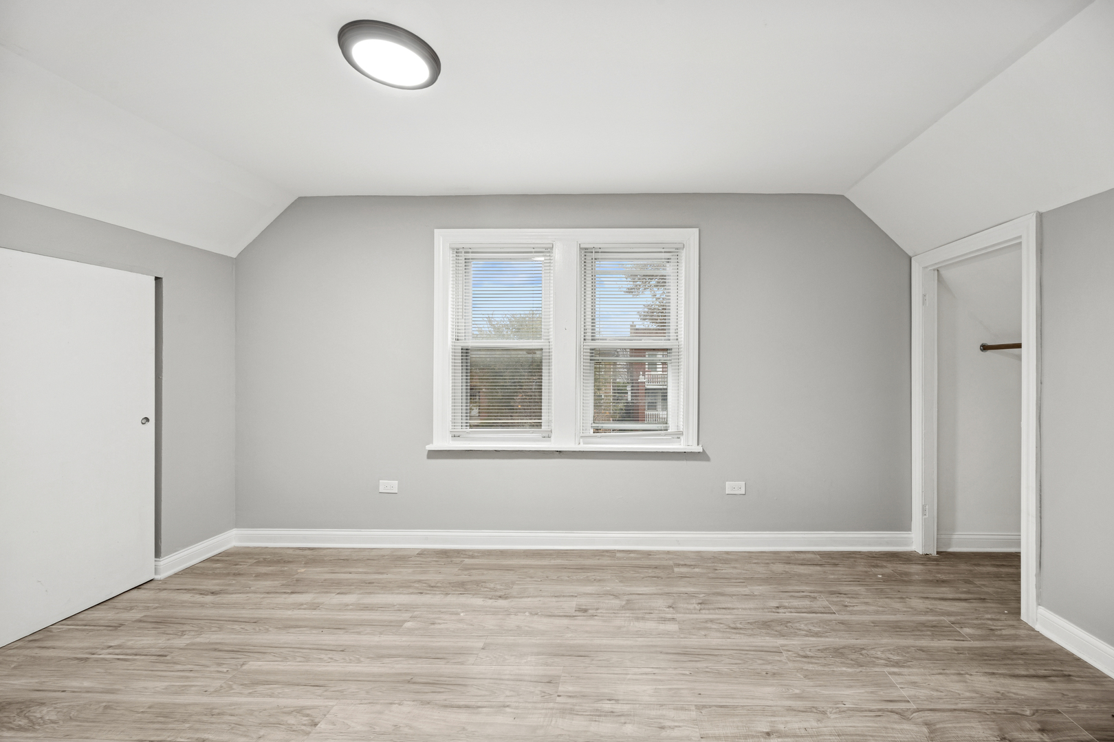 5533 West 63rd Place Chicago, IL 60638 - Photo 9 of 20 a view of an empty room with a window and wooden floor