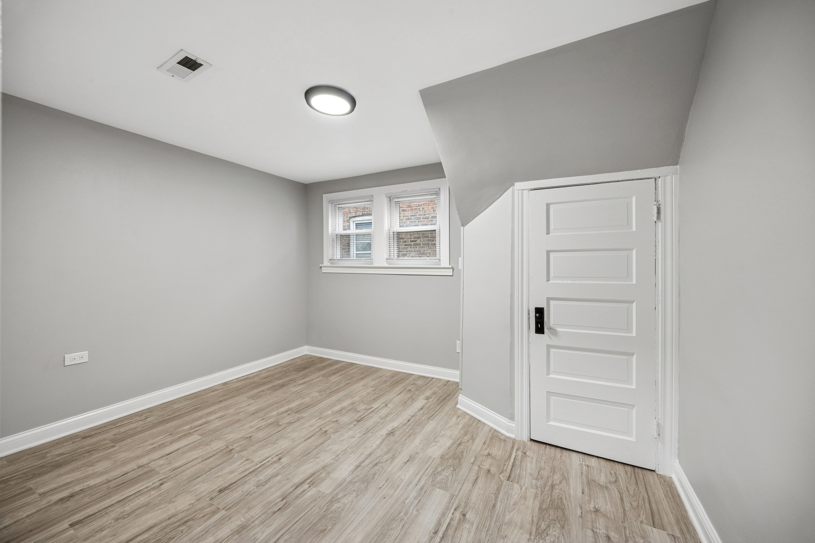 5533 West 63rd Place Chicago, IL 60638 - Photo 10 of 20 an empty room with wooden floor and windows