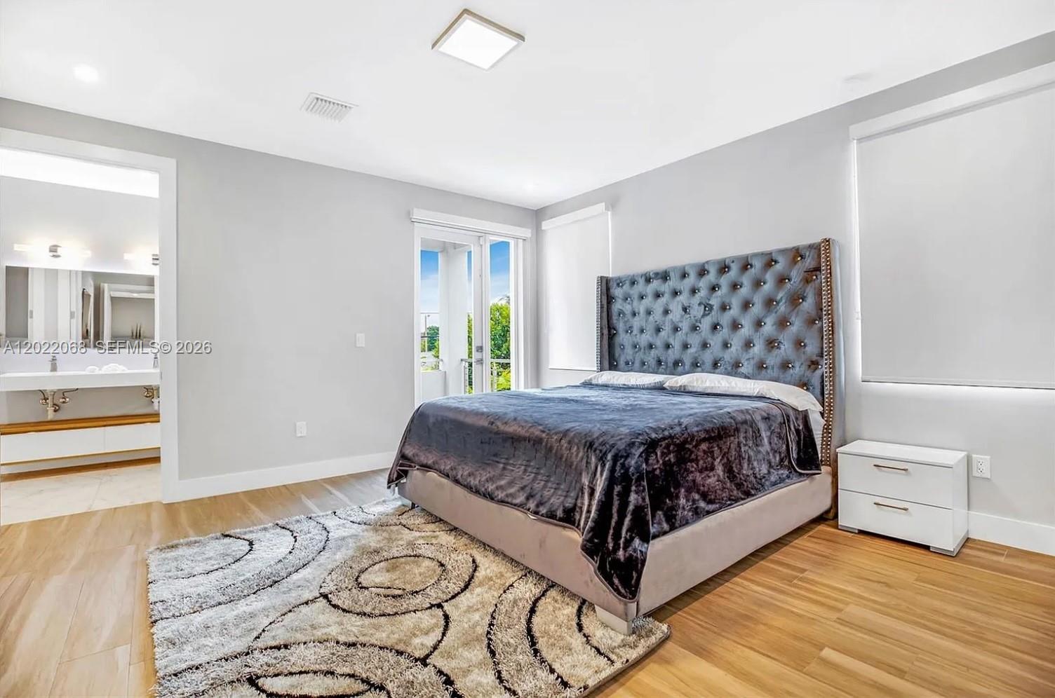 3657 Southwest 26th Street Miami, FL 33133 - Photo 6 of 12 a spacious bedroom with a bed and a window