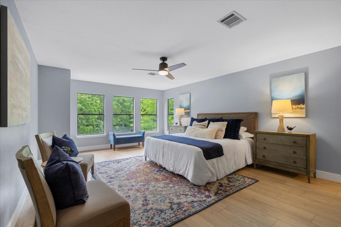 a spacious bedroom with a bed and a couch